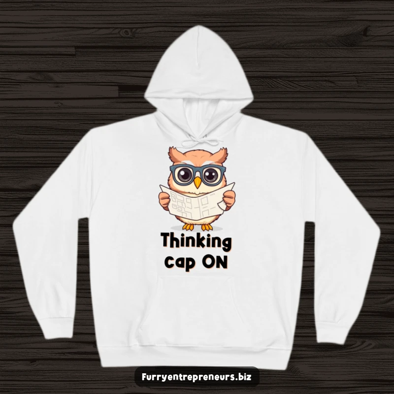 Funny owl wearing glasses, focused on designing a blueprint, depicted on a warm and cozy hoodie for comfort.