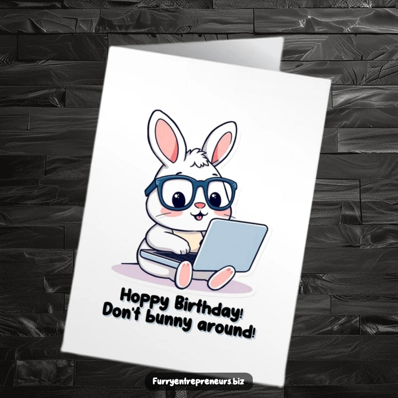 Funny free printable birthday card shows a rabbit wearing glasses, diligently typing on a laptop with a focused expression.